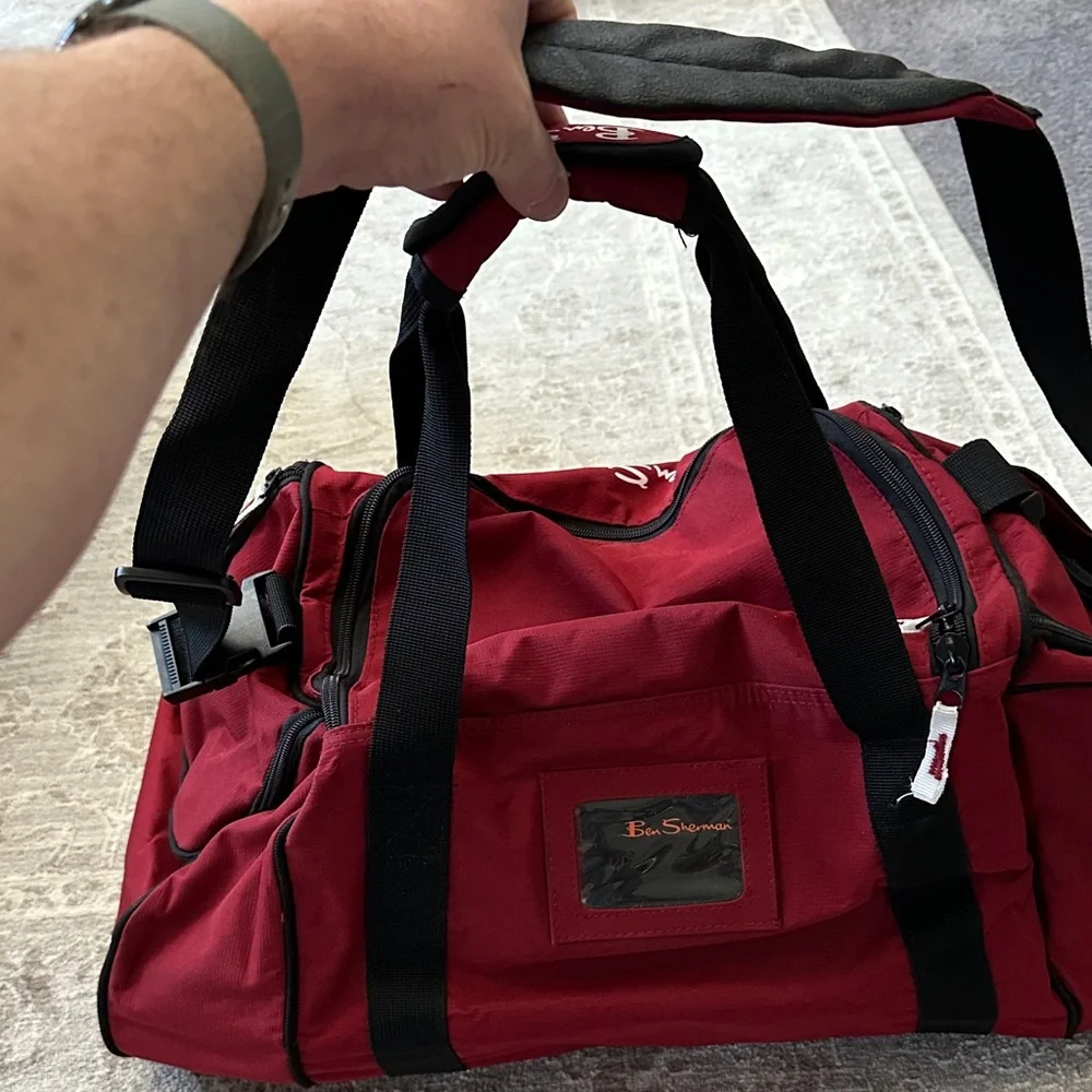 Ben Sherman Burgundy Duffel Bag with Black Accents.